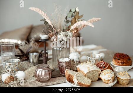 Freshly baked homemade cakes on a festive Easter table. Home serving hygge style. Stock Photo