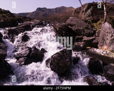 Fast flowing river waterfall linking Llyn Idwal to Llyn Ogwen Cwm Idwal  Ogwen Valley Gwynedd North Wales Stock Photo