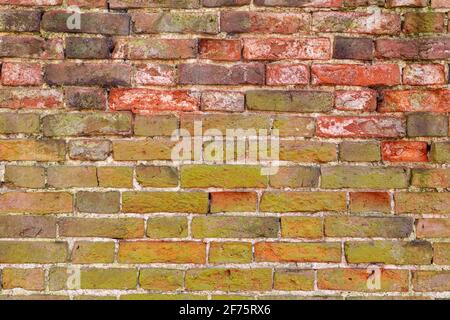 Brick wall background variety of bricks brick wall showing signs of weathering and wear, hand made bricks wirh lime mortar High resolution Stock Photo