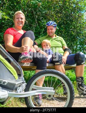 Happy family resting in on sunny place in nature Stock Photo