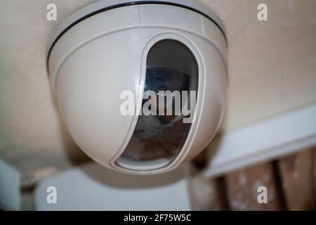 Security camera on the light ceiling in the office Stock Photo