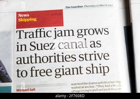 Shipping news 'Traffic jam grows in Suez canal as authorities strive to free giant ship' newspaper headline article Guardian 25 March 2021 London UK Stock Photo