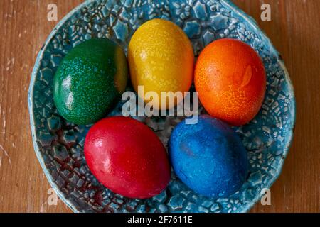 Multicolor colorful five easter eggs on the plate Stock Photo