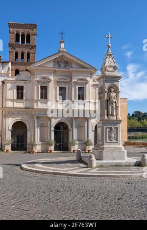 Italy, Basilica of St. Bartholomew on the Island (Basilica di San Bartolomeo all'Isola) and Piazza with Spire of Pius IX (Guglia di Pio IX ) monument Stock Photo