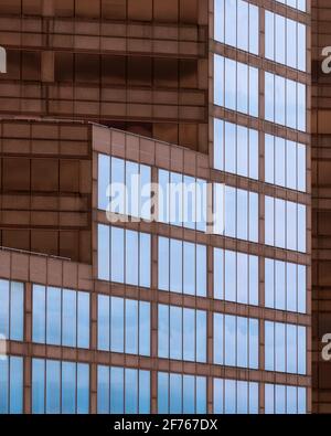 Geometric architectural abstract of reflective windows against brown wall of the Mid America Plaza in Oakbrook Terrace, Illinois Stock Photo