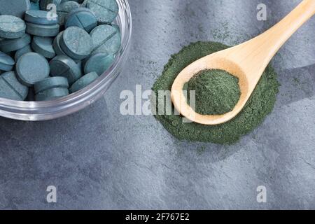 Spirulina powder and pills on the table - Spirulina Stock Photo