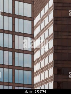 Geometric architectural abstract of reflective windows against brown wall of the Mid America Plaza in Oakbrook Terrace, Illinois Stock Photo