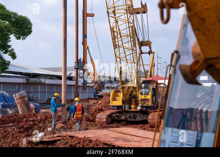 Construction worker Concrete pouring during commercial concreting floors of building in construction site and Civil Engineer or Construction engineer Stock Photo
