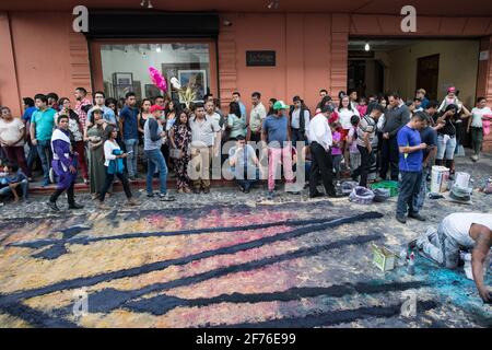 Intricate and vibrant sawdust alfombras decorate the cobblestone streets of Antigua, Guatemala in preparation for the Semana Santa processions. Stock Photo