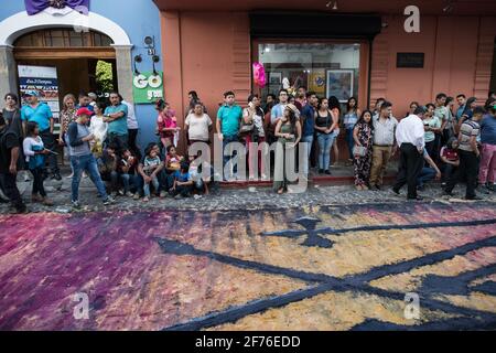 Intricate and vibrant sawdust alfombras decorate the cobblestone streets of Antigua, Guatemala in preparation for the Semana Santa processions. Stock Photo