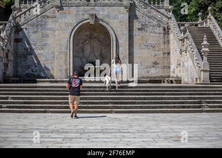 Lamego / Portugal - 07 25 2019 : View of young couple climbing the stairs of Lamego Cathedral with labrador guide dog Stock Photo