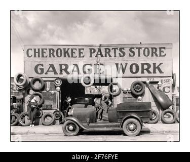 1920's auto motorcar Cherokee Parts Store garage work repair service facility with Ford Model A open-cab pickup truck in foreground USA 1900's Lifestyle fashion post WW1 work employment Stock Photo