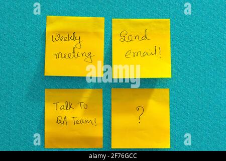 Isolated handwritten reminder notes on a colored sheets of sticky paper. Stock Photo