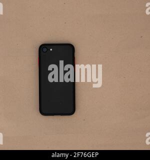 Back of an smart-phone on top of a plain spiral notepad notebook. Stock Photo