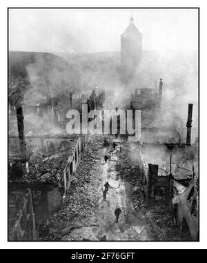 WALDENBURG GERMANY WW2 Artillery Bombing aftermath with American Infantrymen of the 255th Infantry Regiment moving down a street in Waldenburg to hunt out Nazi German Army soldiers and after a recent raid by the USAAF 63rd Division'. In April 1945 at the end of World War II The town had been occupied for a last-ditch stand by the Nazi Wehrmacht against the advancing United States 3rd army, and was almost completely destroyed by American artillery and air attacks Stock Photo