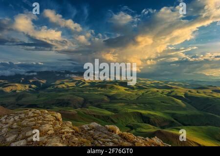 Sunset on hills in Caucasus mountains Stock Photo