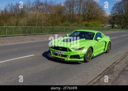 2017 green Ford Mustang GT 5951cc petrol coupe; Vehicular traffic moving vehicles, cars driving vehicle on UK roads, motors, motoring on the M6 motorway highway network. Stock Photo