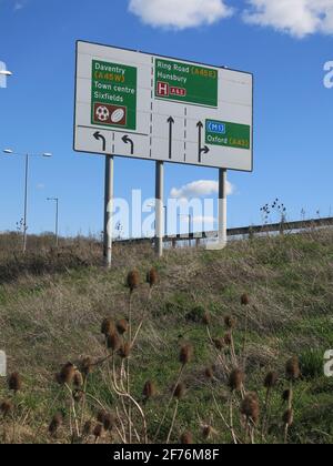 Highway Code: a road sign with the lane markings and directions at a large roundabout (Sixfields) on the A45 on the outskirts of Northampton. Stock Photo