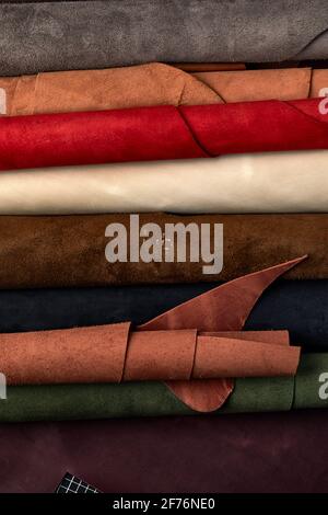 Artificial leather samples on a cow leather background. Top view Stock Photo
