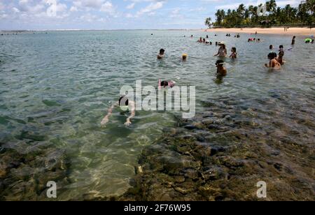 marau, bahia / brazil - december 27, 2011: People are seen diving in a natural pool on the beach of Taipu de Fora, in Barra Grande district, in the mu Stock Photo