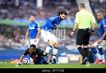 Crystal Palace's Jordan Ayew (left) goes down under the challenge from Everton's Andre Gomes (right) during the Premier League match at Goodison Park, Liverpool. Issue date: Monday April 5, 2021. Stock Photo