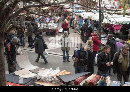 Saint Denis, Paris. Political activist handing out pamphlets at weekend market Stock Photo