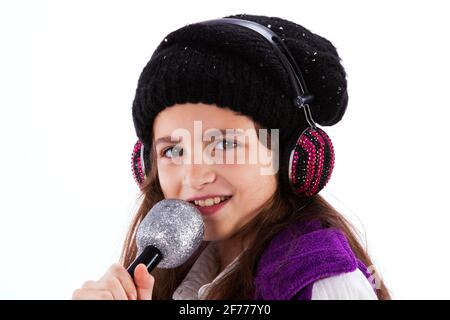 Female child singing with a mic and headphones Stock Photo