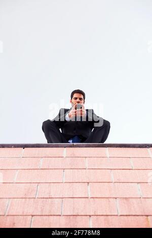 Businessman using his smartphone Stock Photo