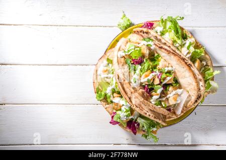 Mediterranean food. Doner Kebap, Taco, Shawarma, greek wrapped gyros sandwich, tortilla pita bread stuffed grilled chicken meat, fresh vegetables, tsa Stock Photo