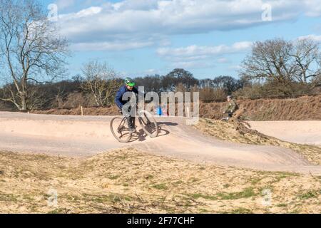 Mountain and BMX bike track at Edenbrook Country Park with cyclists, Fleet, Hampshire, UK Stock Photo