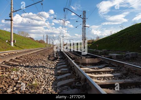 Railway departing in different directions against the background of a cloudy sky Stock Photo