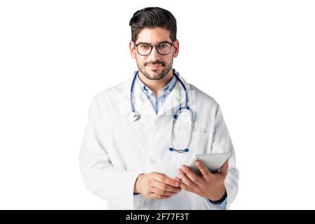 Portrait shot of male doctor holding digital tablet in his hand while standing at isolated white background. Copy space. Stock Photo