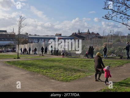 Parents in line with social distancing to pick their children from a primary school which reopened after three months of closure due to lockdown to prevent the spread of the Coronavirus pandemic in London, England, UK. Stock Photo