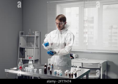 Young male chemist experimenting in a lab. Stock Photo