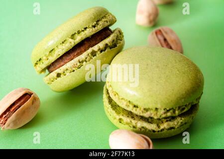 French dessert, sweet meringue based confectionery and expensive sweets concept with close up on green pistachio flavored macaroon or macaron with a b Stock Photo