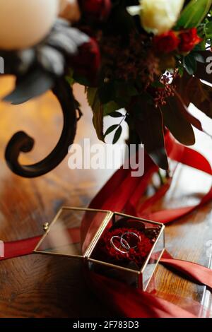 Close-up of bridal bouquet and wedding rings on table Stock Photo