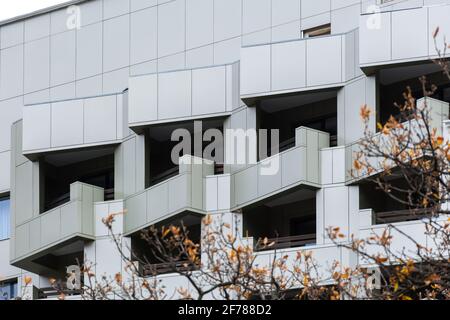 Ventilated grey facade. Abstract architectural background. Square geometric pattern of tiles on the balconies of an office or residential building. Co