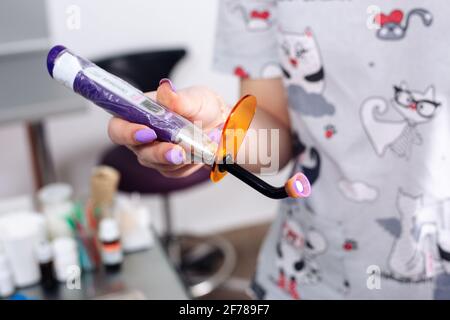 Cordless LED curing light for curing fillings. Dental equipment. Stock Photo