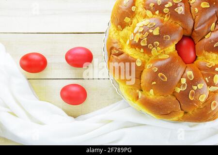 Easter candle,Easter red eggs and Easter bread on wooden table Stock Photo