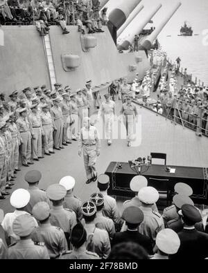 1940s SEPTEMBER 2 1945 JAPANESE OFFICIAL SURRENDER ON BOARD USS MISSOURI GENERAL MCARTHUR & ADMIRAL NIMITZ ENTERING THE CEREMONY - q73540 CPC001 HARS FULL-LENGTH END PERSONS INSPIRATION MALES FORCE CEREMONY B&W GOALS SUCCESS TOKYO HIGH ANGLE VICTORY DOUGLAS ENTERING NAVAL AND EXCITEMENT EXTERIOR LEADERSHIP MISSOURI WORLD WARS WORLD WAR WORLD WAR TWO WORLD WAR II IN ON AUTHORITY OCCUPATIONS POLITICS UNIFORMS BATTLESHIP CHESTER FORCES NAVIES OFFICIAL WORLD WAR 2 USN 1945 COOPERATION NIMITZ SEPTEMBER 2 SURRENDER USS ADMIRAL BLACK AND WHITE OLD FASHIONED SEPTEMBER Stock Photo