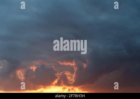 dark stormy clouds on sunset sky Stock Photo