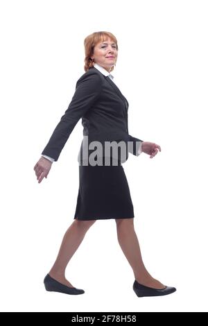 Full body shot profile view of senior businesswoman walking Stock Photo