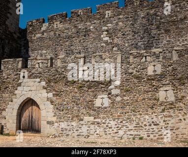 The castle of Sabugal built around 1300 commands the region at the river Coa close to the border to Spain. Detail of a wall with several loop-holes in the form of crosses. Stock Photo