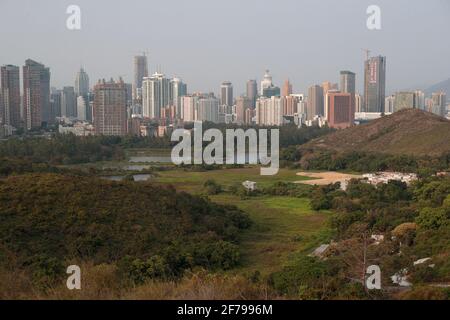 Luohu area of Shenzhen City, viewed over green fields near Liu Pok, New Territories, Hong Kong, China 25th March 2021 Stock Photo