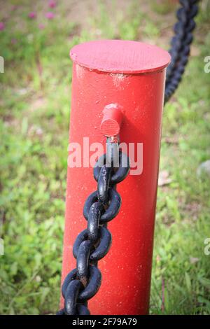 A vertical photo of a red chain link fence Stock Photo