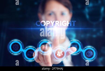 Business, Technology, Internet and network concept. Young businessman working on a virtual screen of the future and sees the inscription: Copyright Stock Photo