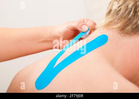 Patient at the physiotherapy with different tapes Stock Photo