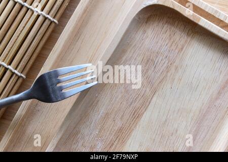 Wooden tray and fork Stock Photo
