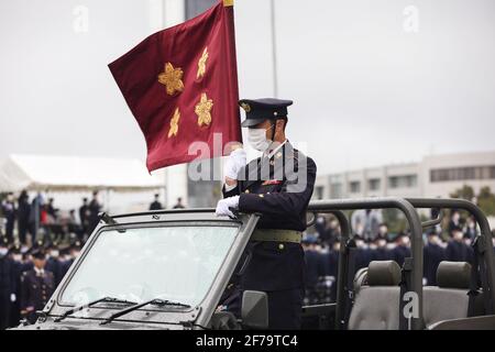 Student of the National Defense Academy carries the standard of the Minister of Defense of Japan during a military parade.Japan's Vice-minister of Defense Yasuhide Nakayama attends the entrance ceremony of the National Defense Academy. The NDA is military academy which educates and trains future leaders of three Japan Self-Defense Forces. Its educational curricula perfectly satisfy the Japanese University Standards which other ordinary universities follow as well. Therefore graduates of the Academy receive academic degrees in Science, Engineering, or Social Science.” (Photo by Stanislav Kogiku Stock Photo