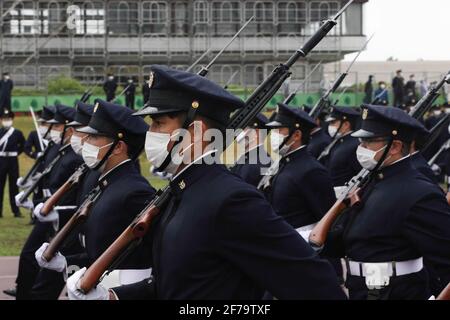 Students of the National Defense Academy parade the Japanese flag 